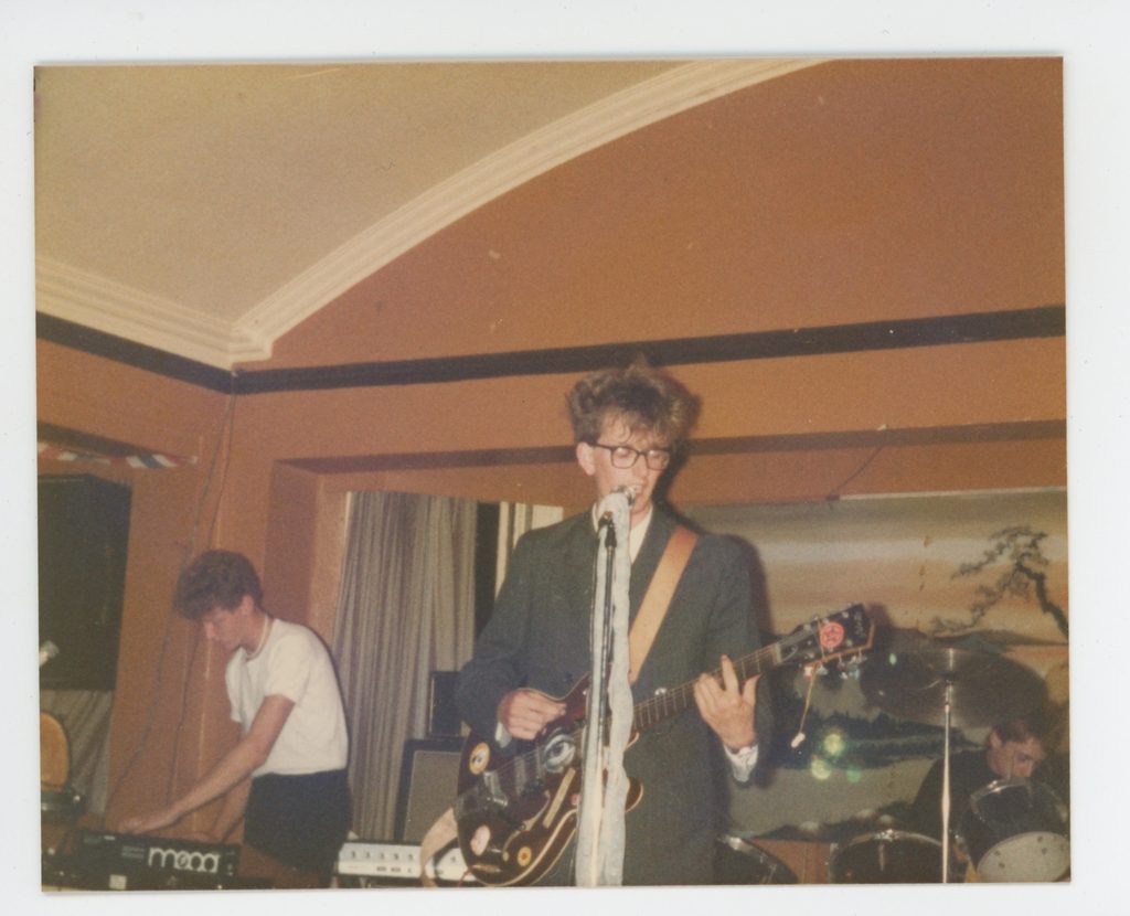 A photo of an early Pulp gig, with a teenage Jarvis Cocker wearing large glasses and big hair